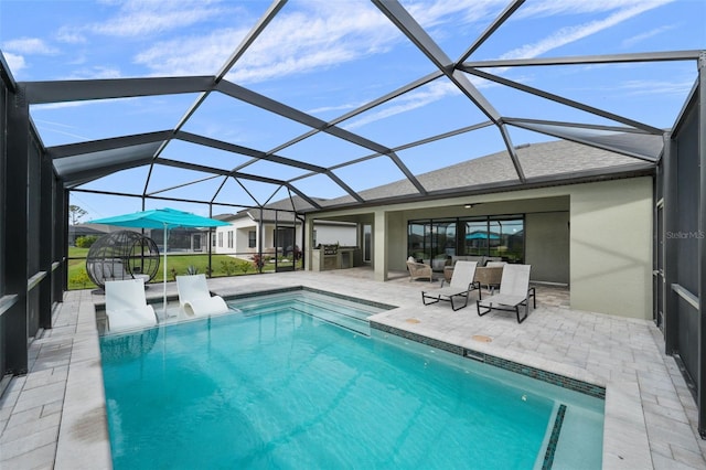 outdoor pool featuring glass enclosure and a patio