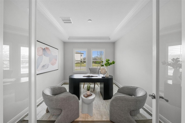 office space featuring visible vents, baseboards, and ornamental molding