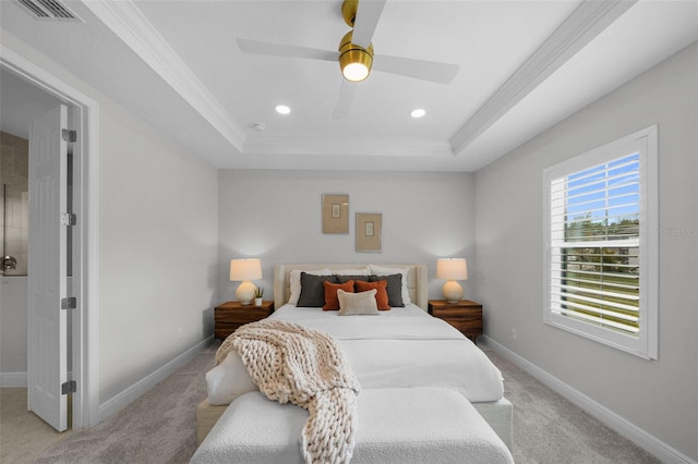 bedroom with a tray ceiling, carpet, visible vents, and baseboards