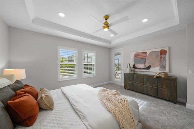 bedroom with a tray ceiling, a ceiling fan, baseboards, and light carpet