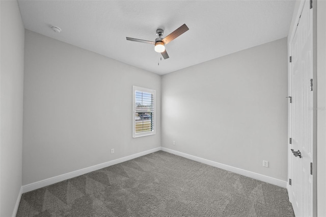 carpeted spare room with baseboards and ceiling fan