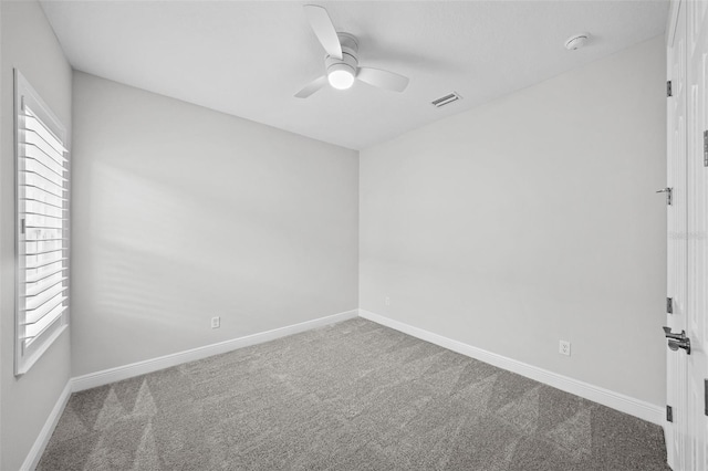 unfurnished room featuring visible vents, baseboards, carpet, and a ceiling fan