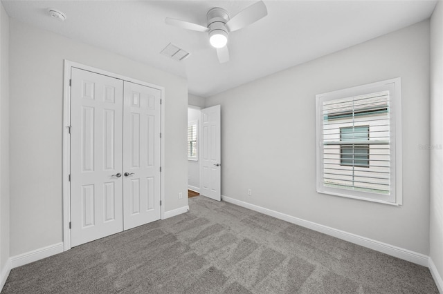 unfurnished bedroom featuring a closet, visible vents, baseboards, and carpet