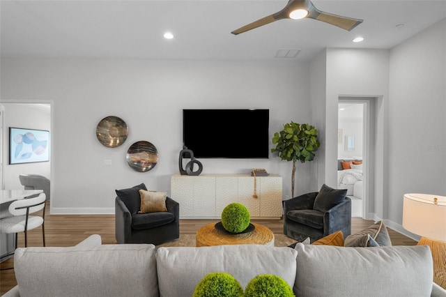 living area with visible vents, recessed lighting, wood finished floors, and baseboards