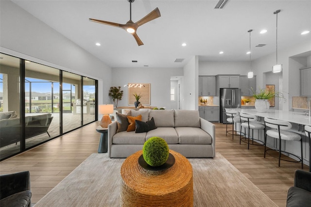 living room featuring visible vents, recessed lighting, light wood-style floors, and ceiling fan