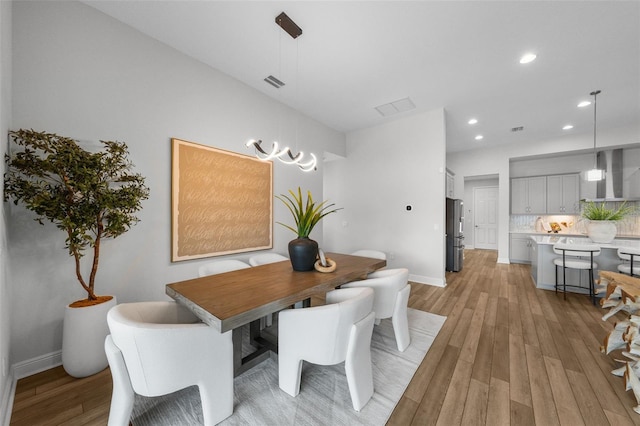 dining room with light wood-style flooring, recessed lighting, visible vents, and baseboards