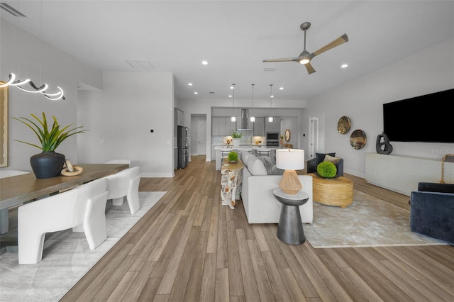 living area with visible vents, baseboards, ceiling fan, recessed lighting, and light wood-style floors