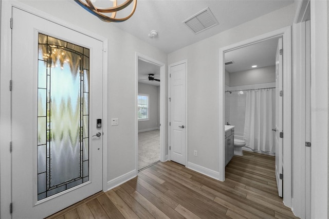 interior space featuring visible vents, baseboards, and wood finished floors