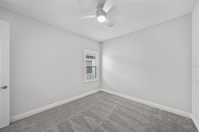 empty room featuring a ceiling fan, carpet, and baseboards