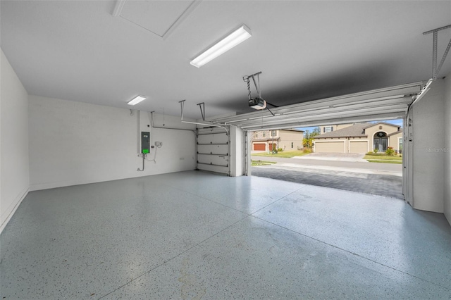 garage featuring electric panel and a garage door opener