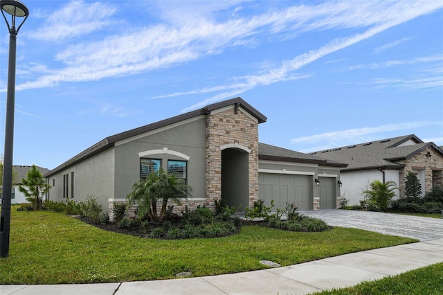 view of front of home featuring stucco siding, decorative driveway, stone siding, a front yard, and a garage