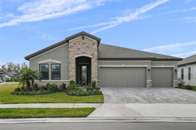 view of front of home with stone siding, stucco siding, an attached garage, and decorative driveway