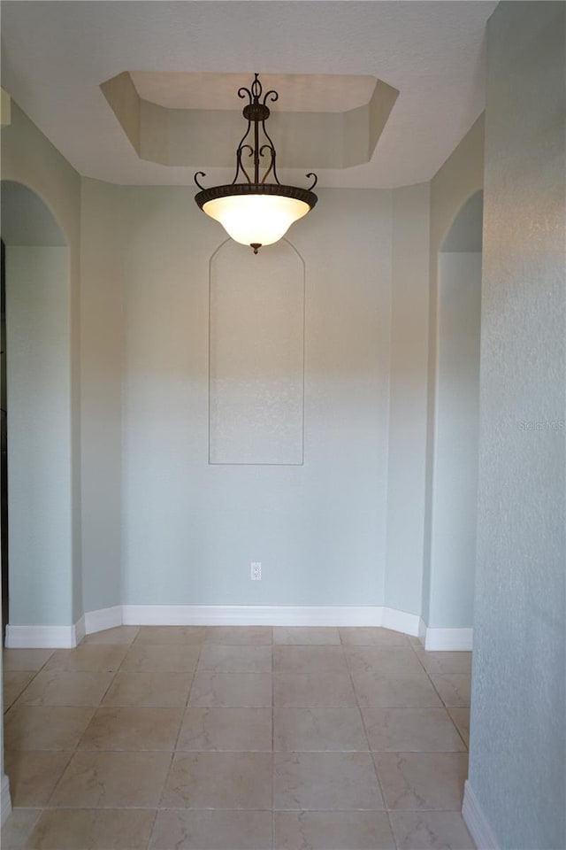 spare room with a raised ceiling