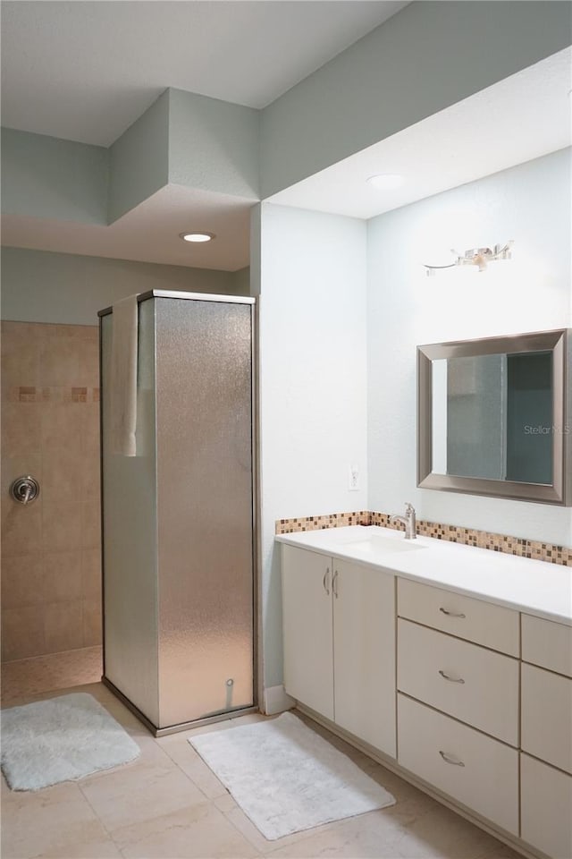 bathroom featuring vanity and tiled shower