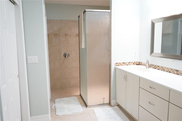 bathroom featuring vanity, tile patterned flooring, and a shower with door