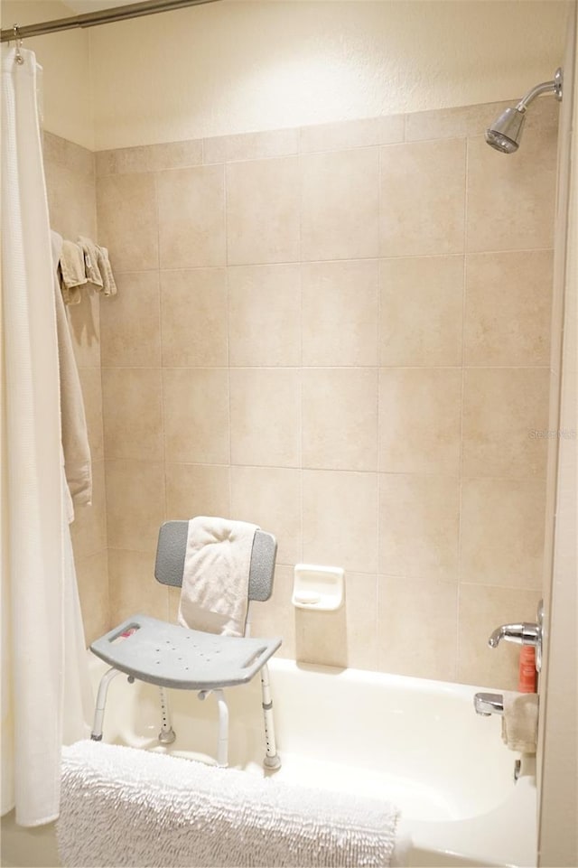 bathroom with shower / bath combination with curtain