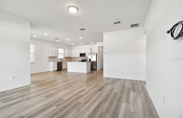 unfurnished living room with light hardwood / wood-style flooring