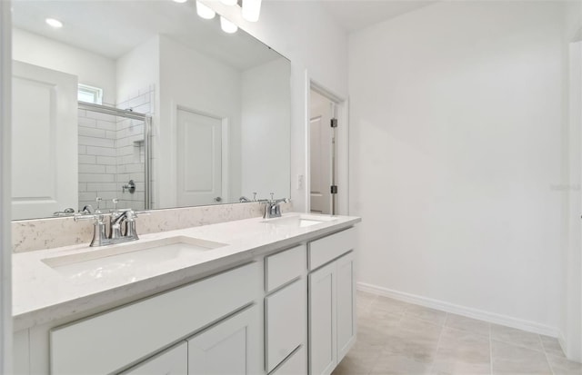 bathroom featuring vanity, tile patterned flooring, and a shower with door