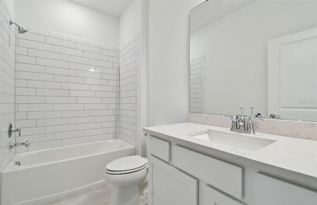 full bathroom featuring vanity, tile patterned flooring, tiled shower / bath, and toilet