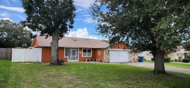 single story home featuring a front lawn and a garage