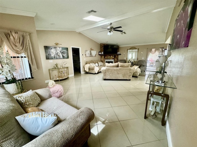 living room with light tile patterned floors, crown molding, a large fireplace, ceiling fan, and vaulted ceiling with beams