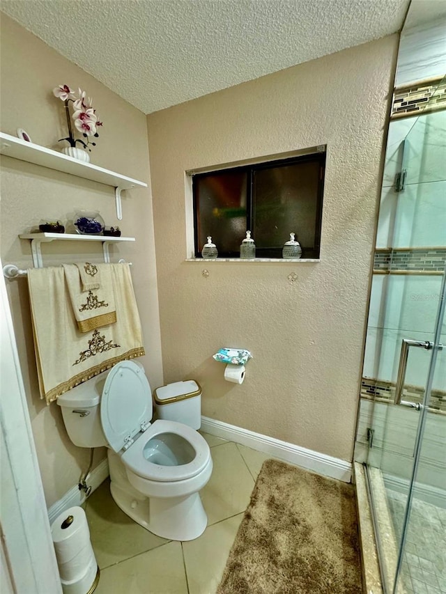 bathroom with tile patterned floors, toilet, and a textured ceiling