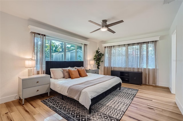 bedroom with light hardwood / wood-style flooring and ceiling fan