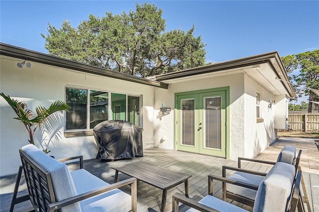 deck with french doors and a grill