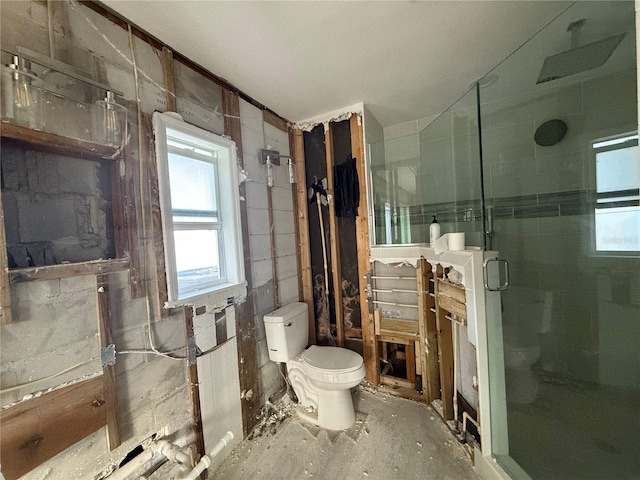 bathroom with an enclosed shower and toilet