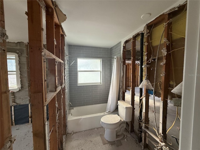 bathroom with toilet and shower / tub combo with curtain