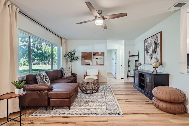 living room with ceiling fan and light hardwood / wood-style floors