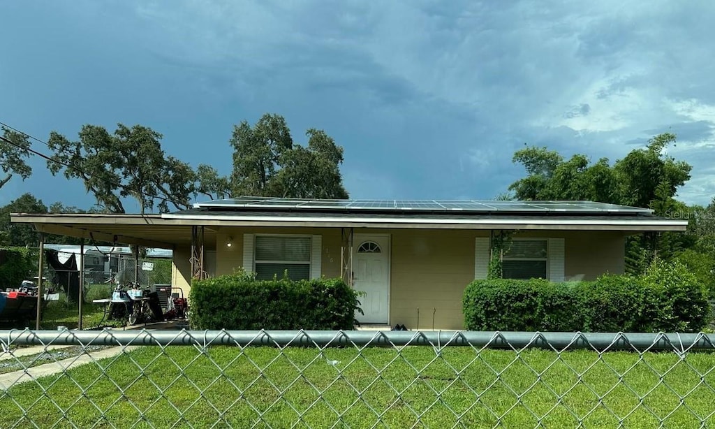 view of front of home with covered porch and a front lawn