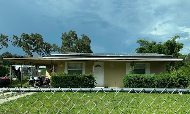 view of front of home with covered porch and a front lawn