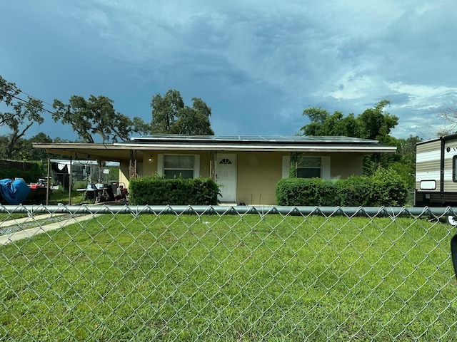 view of front facade with a front yard and a carport