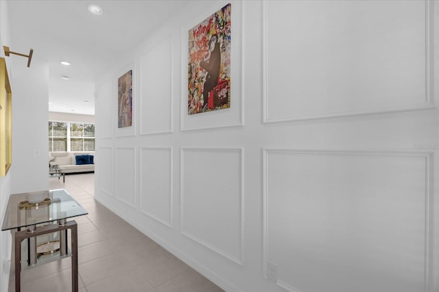 hall featuring light tile patterned floors