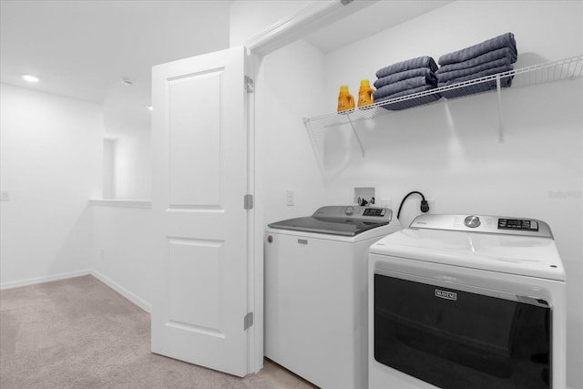 washroom with light colored carpet and washer and clothes dryer