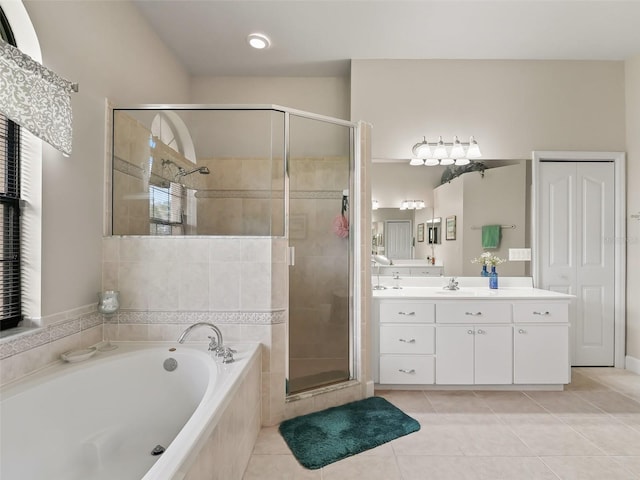 bathroom with plenty of natural light, shower with separate bathtub, vanity, and tile patterned floors