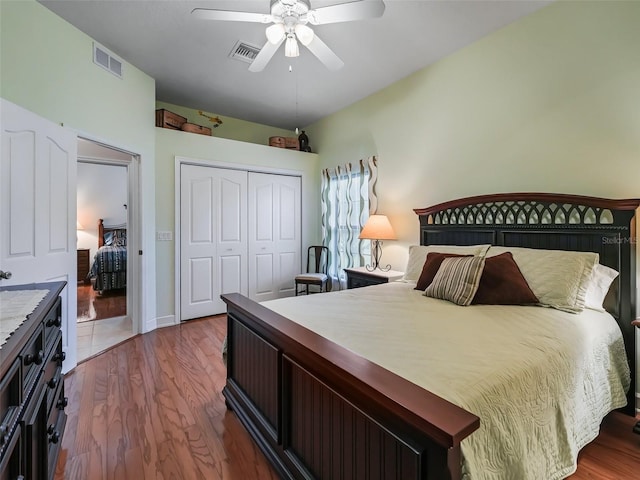 bedroom with ceiling fan, dark hardwood / wood-style floors, and a closet