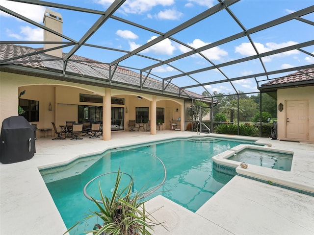 view of pool featuring an in ground hot tub, a patio area, and a lanai