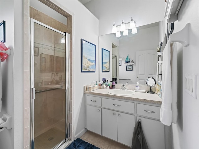 bathroom with tile patterned floors, vanity, and a shower with shower door