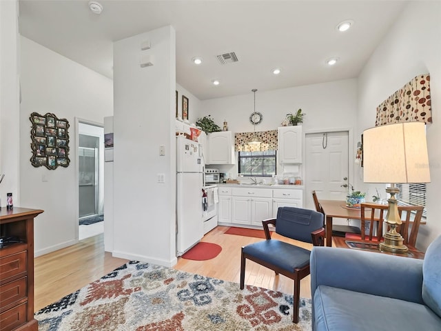 living room with sink and light hardwood / wood-style flooring