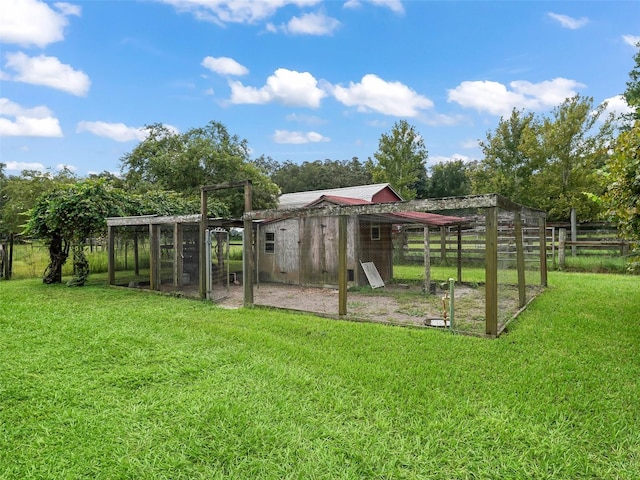 view of yard featuring a rural view and an outbuilding