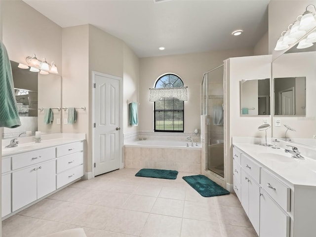 bathroom with tile patterned flooring, shower with separate bathtub, and vanity