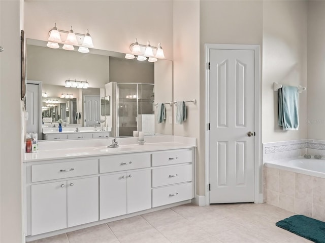 bathroom featuring shower with separate bathtub, tile patterned floors, and vanity