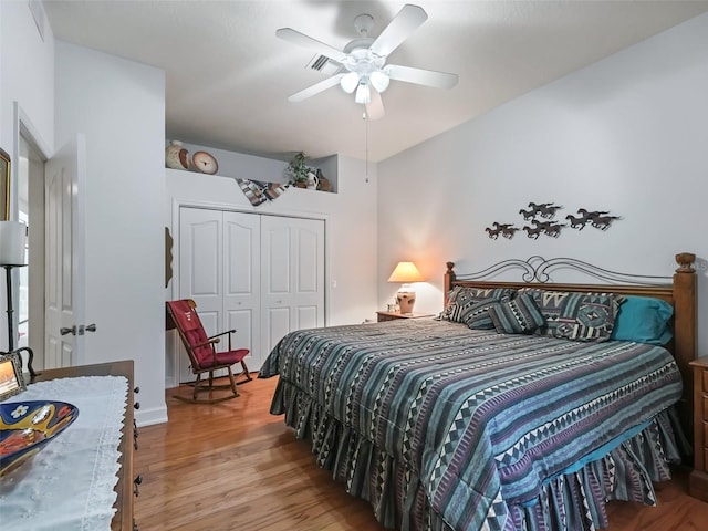 bedroom with a closet, ceiling fan, and light wood-type flooring