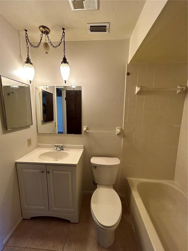 bathroom featuring tile patterned flooring, vanity, and toilet