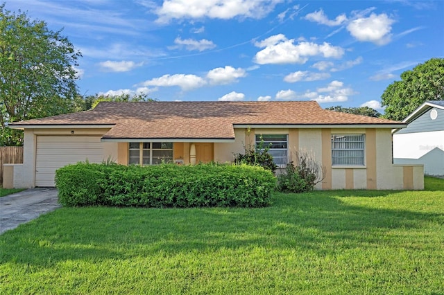 single story home featuring a garage and a front lawn