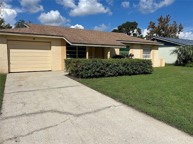 single story home with a garage and a front lawn