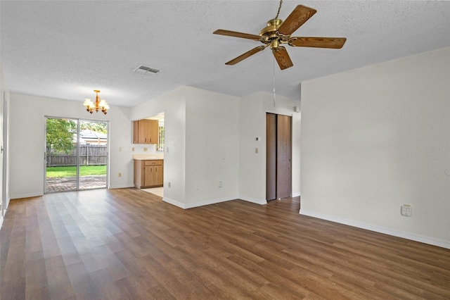 unfurnished living room featuring ceiling fan with notable chandelier, dark wood-type flooring, and a textured ceiling