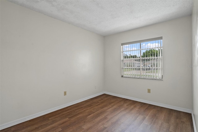 unfurnished room featuring hardwood / wood-style floors and a textured ceiling